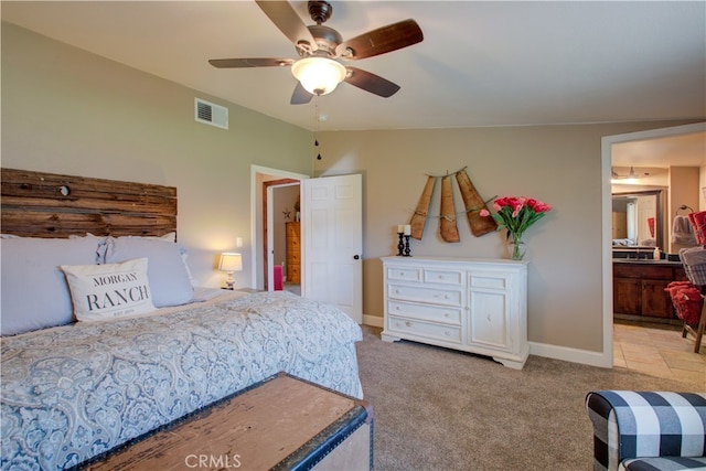 carpeted bedroom featuring ensuite bath, vaulted ceiling, and ceiling fan