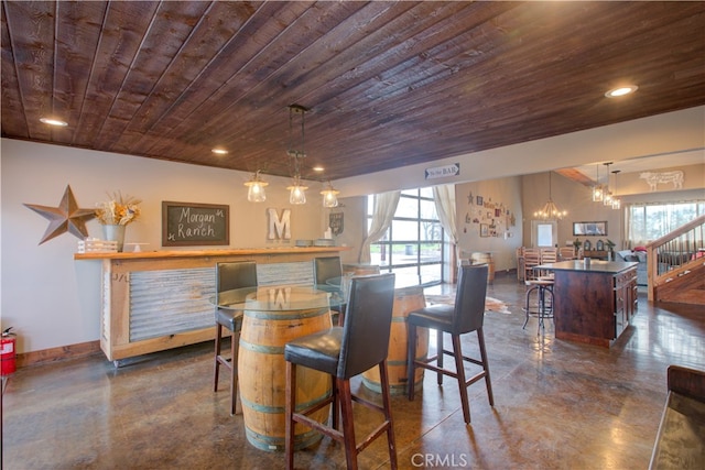 interior space with an inviting chandelier, a healthy amount of sunlight, and wooden ceiling