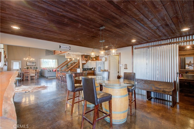 dining space featuring an inviting chandelier and wood ceiling