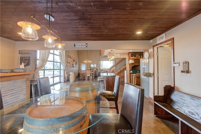 dining space with wood ceiling, an inviting chandelier, and concrete flooring