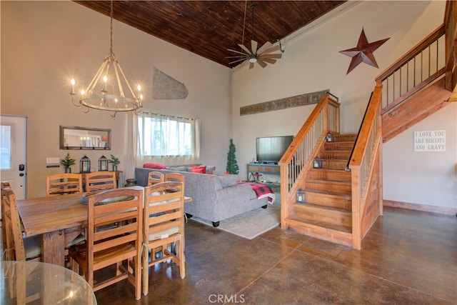 dining area with a towering ceiling, ceiling fan with notable chandelier, and wooden ceiling