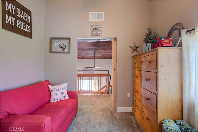 living area featuring ceiling fan and carpet floors