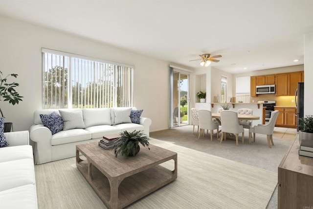 living room featuring light carpet and ceiling fan