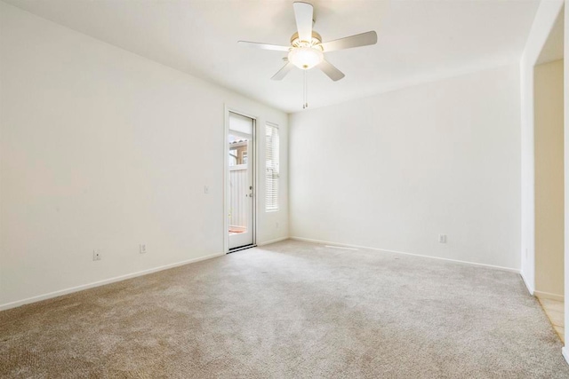 unfurnished room with light colored carpet and ceiling fan