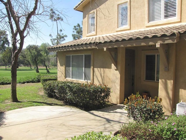 doorway to property featuring a lawn