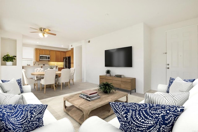 living room with light carpet and ceiling fan