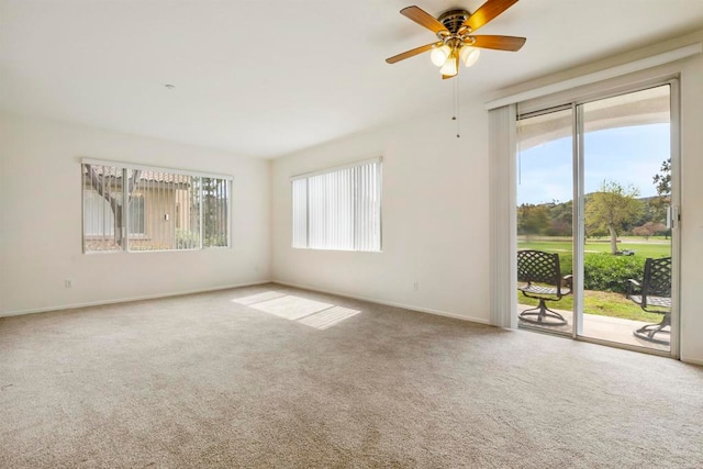 carpeted spare room with ceiling fan