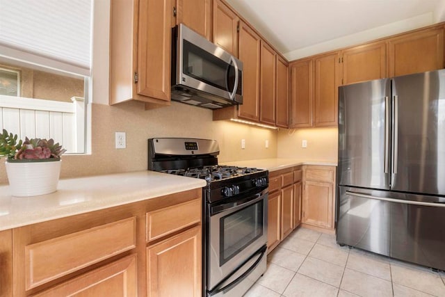 kitchen with stainless steel appliances and light tile patterned floors