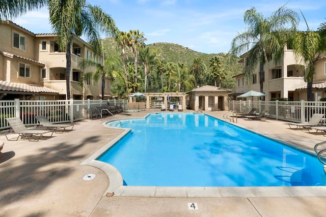 view of pool featuring a patio area and a mountain view