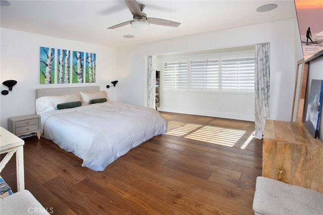 bedroom with ceiling fan and dark hardwood / wood-style floors