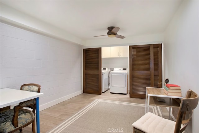 interior space with cabinets, ceiling fan, light hardwood / wood-style flooring, and washer and dryer