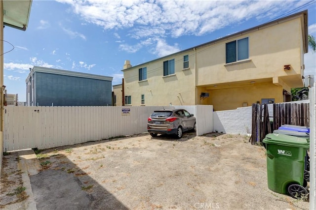 exterior space with fence and stucco siding