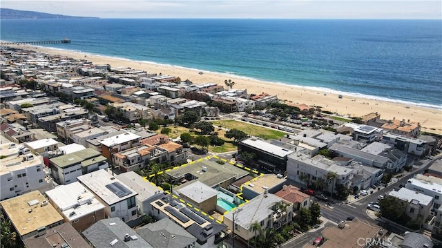 birds eye view of property with a water view and a view of the beach