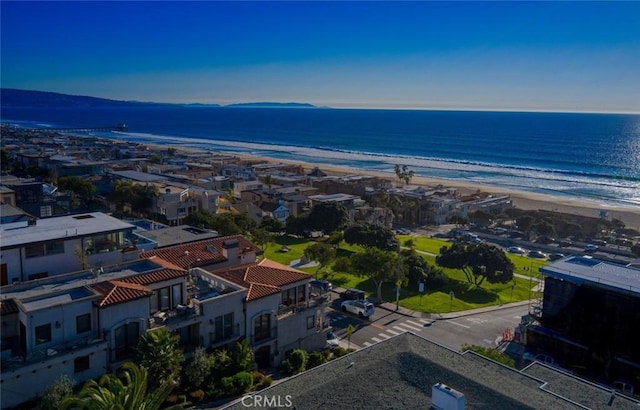 birds eye view of property featuring a water view and a beach view