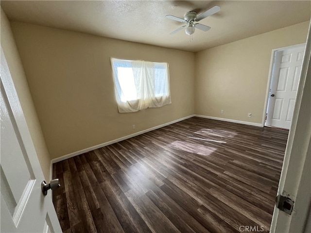 unfurnished bedroom featuring ceiling fan and dark hardwood / wood-style floors