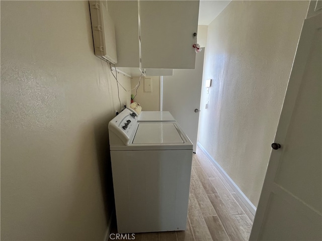 laundry area featuring light hardwood / wood-style flooring and washer and clothes dryer