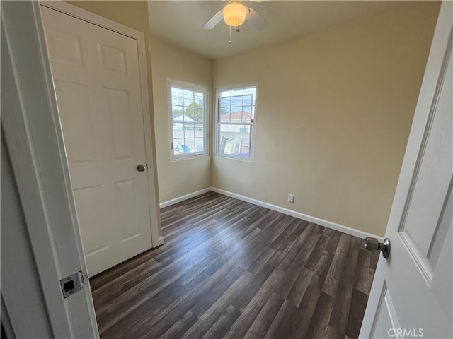 unfurnished bedroom featuring ceiling fan and dark hardwood / wood-style flooring