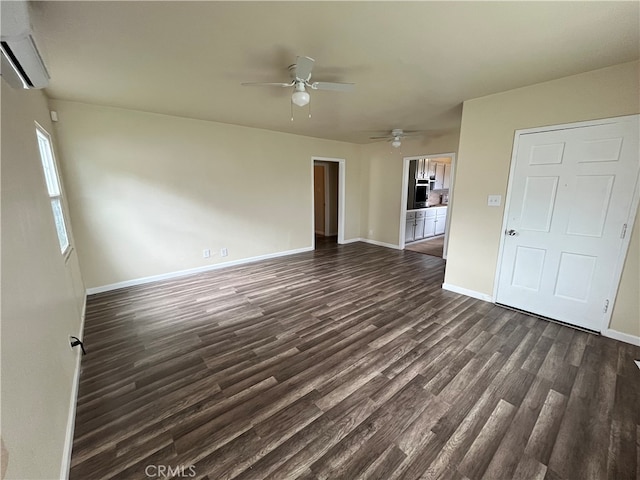 unfurnished living room featuring ceiling fan, a wall mounted AC, and dark hardwood / wood-style flooring