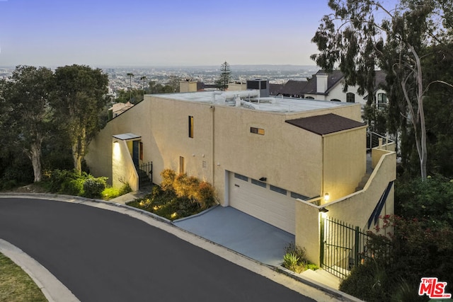 view of front of house with central AC and a garage