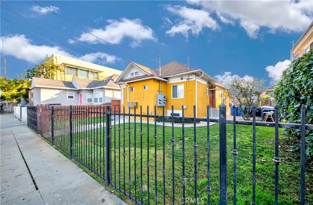 bungalow-style home featuring a front yard