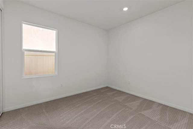 unfurnished room with light carpet