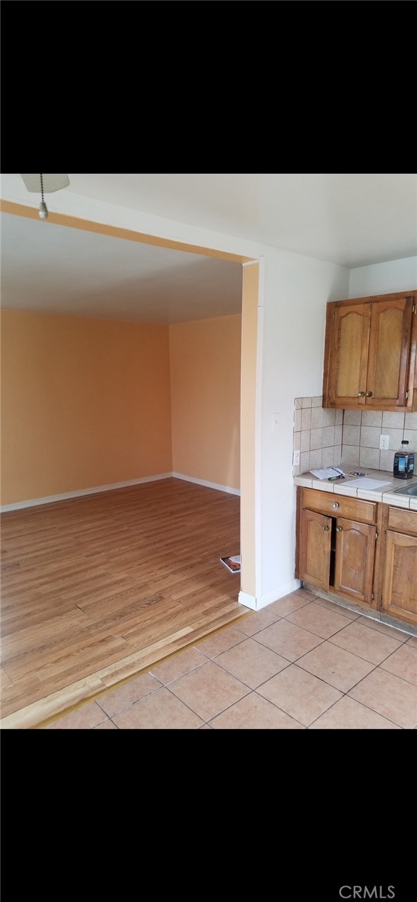 kitchen with backsplash and light wood-type flooring