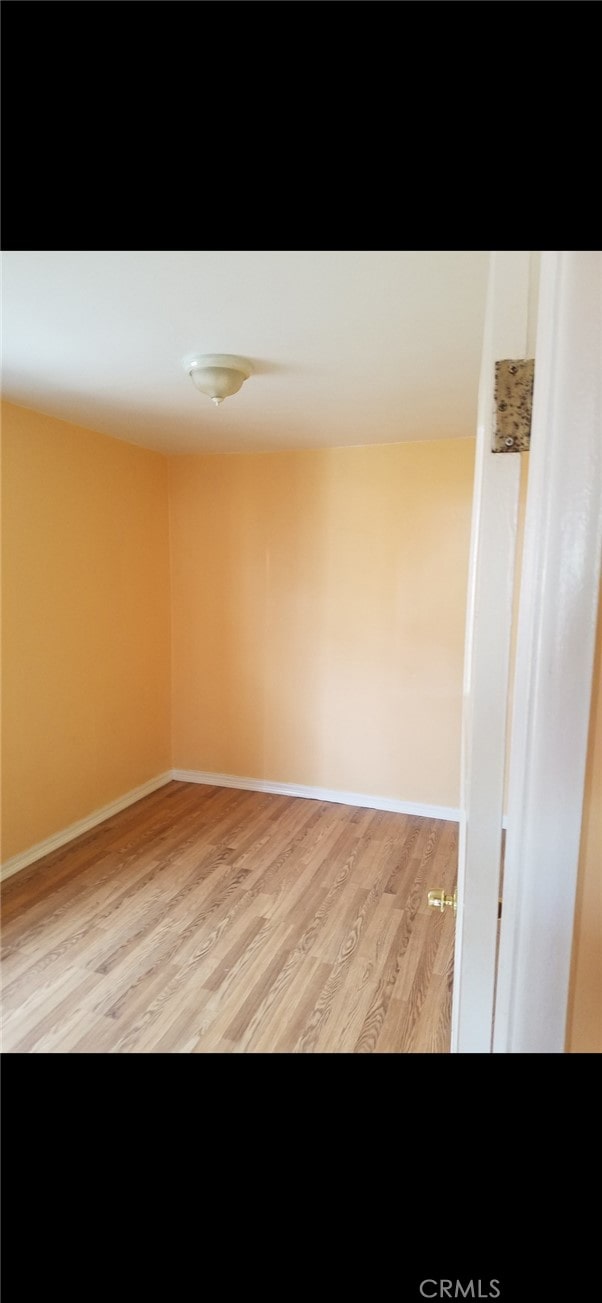 empty room with light hardwood / wood-style flooring