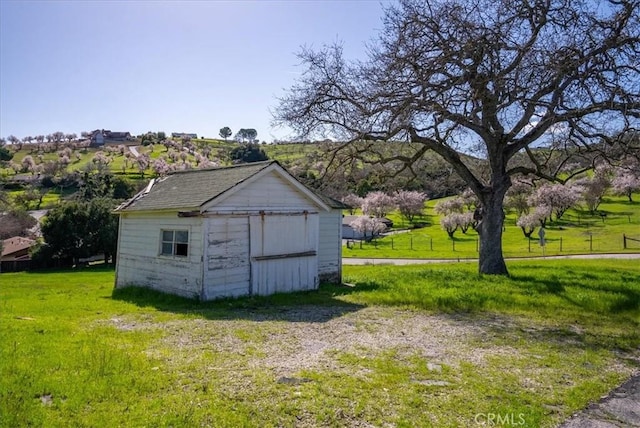 view of outbuilding with a lawn