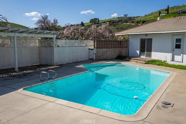 view of swimming pool with a patio area and a pergola