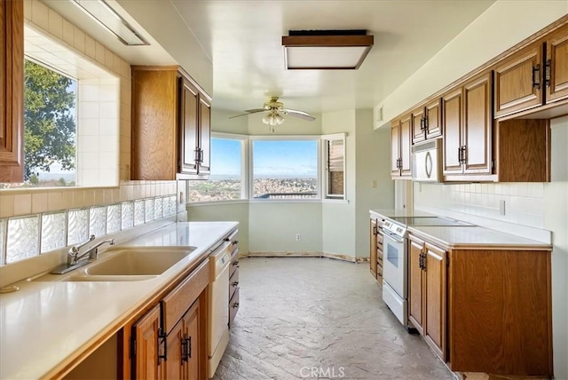 kitchen featuring white appliances, tasteful backsplash, a wealth of natural light, and ceiling fan