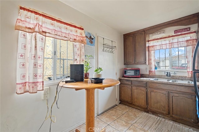 6820 S Van Ness Ave, Los Angeles, CA 90047 - kitchen with a sink and light tile patterned floors