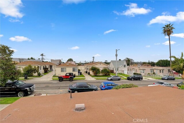 6820 S Van Ness Ave, Los Angeles, CA 90047 - view of asphalt street featuring a residential view, street lighting, and sidewalks
