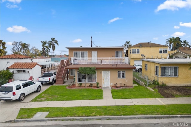 6820 S Van Ness Ave, Los Angeles, CA 90047 - view of property featuring stucco siding, a front lawn, and stairway