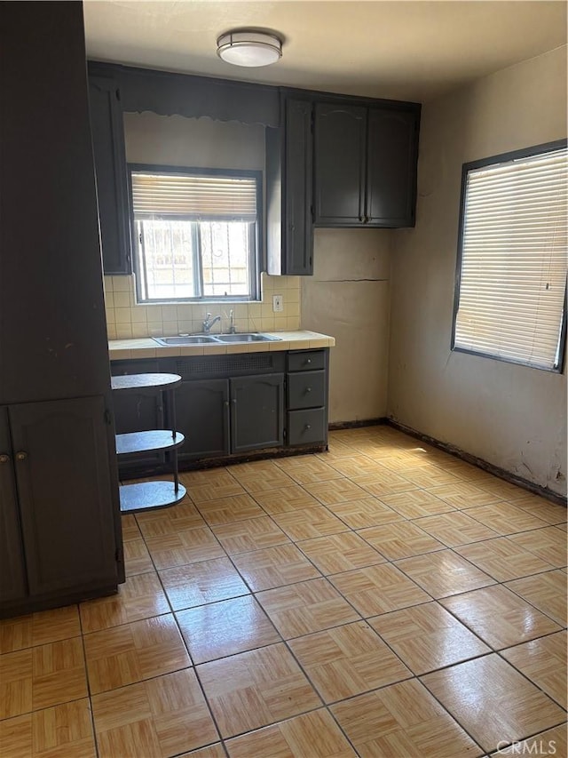 6820 S Van Ness Ave, Los Angeles, CA 90047 - kitchen featuring tile countertops and backsplash