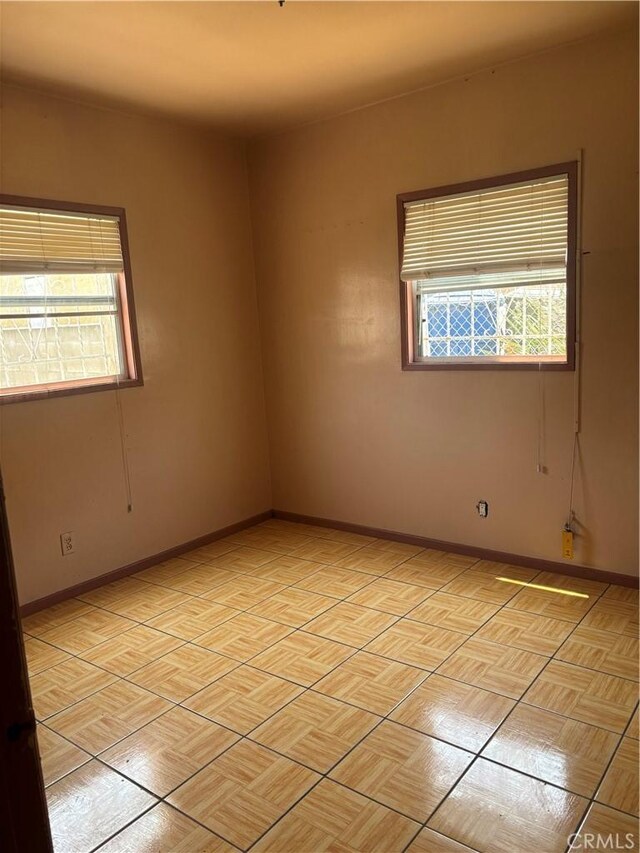 6820 S Van Ness Ave, Los Angeles, CA 90047 - spare room featuring baseboards