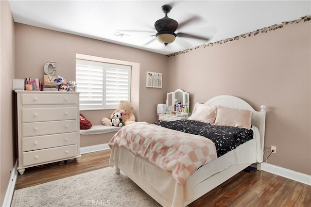 bedroom with ceiling fan and dark hardwood / wood-style flooring