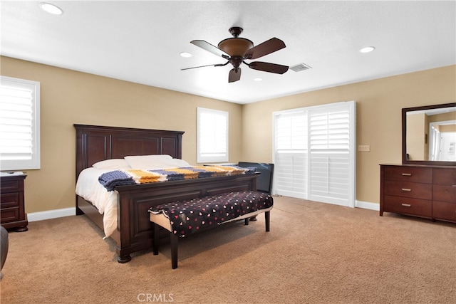 bedroom featuring ceiling fan and light colored carpet