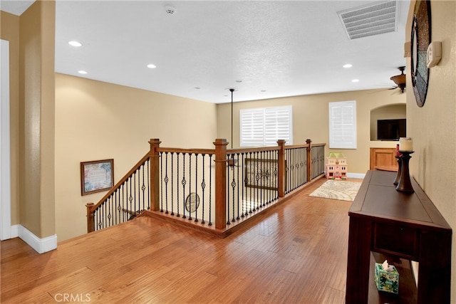 corridor with hardwood / wood-style floors