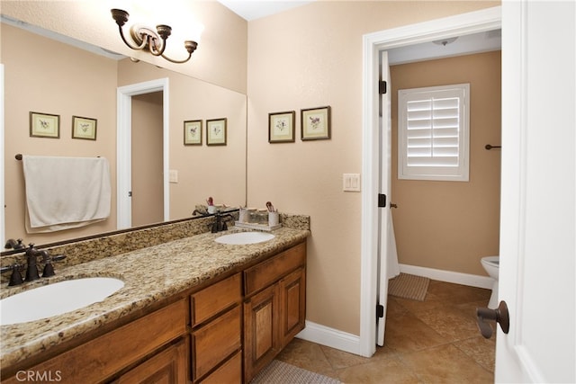 bathroom with vanity, toilet, and tile patterned floors