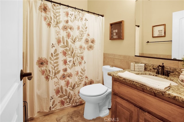 bathroom featuring a shower with curtain, vanity, tile patterned flooring, and toilet