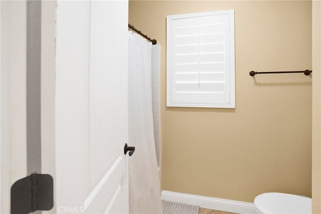 bathroom with walk in shower and toilet