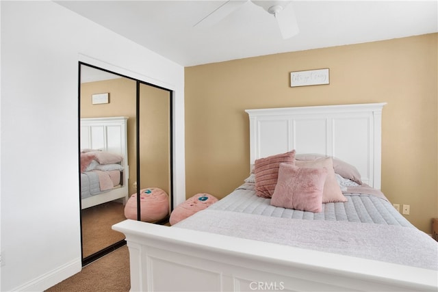 bedroom with ceiling fan, light colored carpet, and a closet