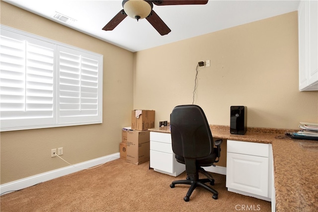 office area featuring light carpet and ceiling fan