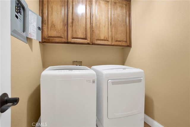 laundry room featuring washing machine and dryer and cabinets