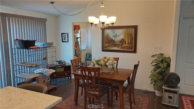 dining space with an inviting chandelier and dark hardwood / wood-style floors