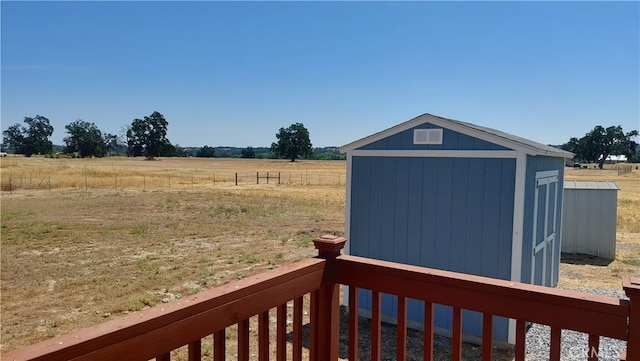 view of yard featuring a rural view and a storage unit