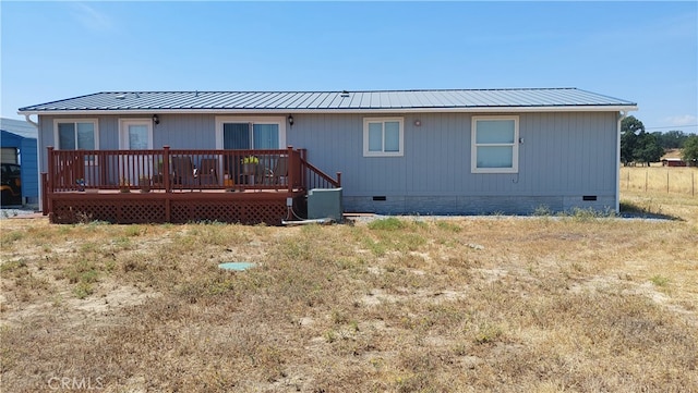 rear view of house featuring a wooden deck