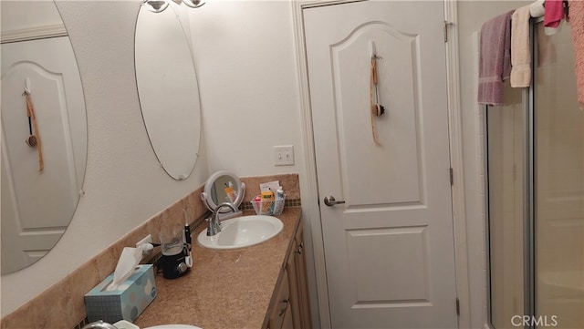 bathroom with vanity and an enclosed shower