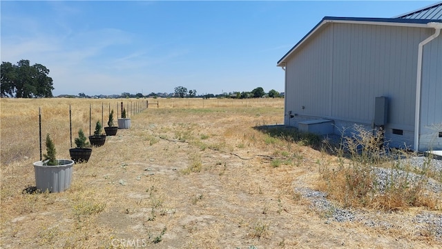 view of yard with a rural view