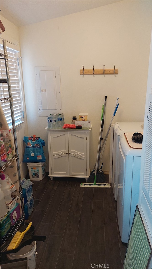 laundry area with dark hardwood / wood-style floors, electric panel, and washer and dryer